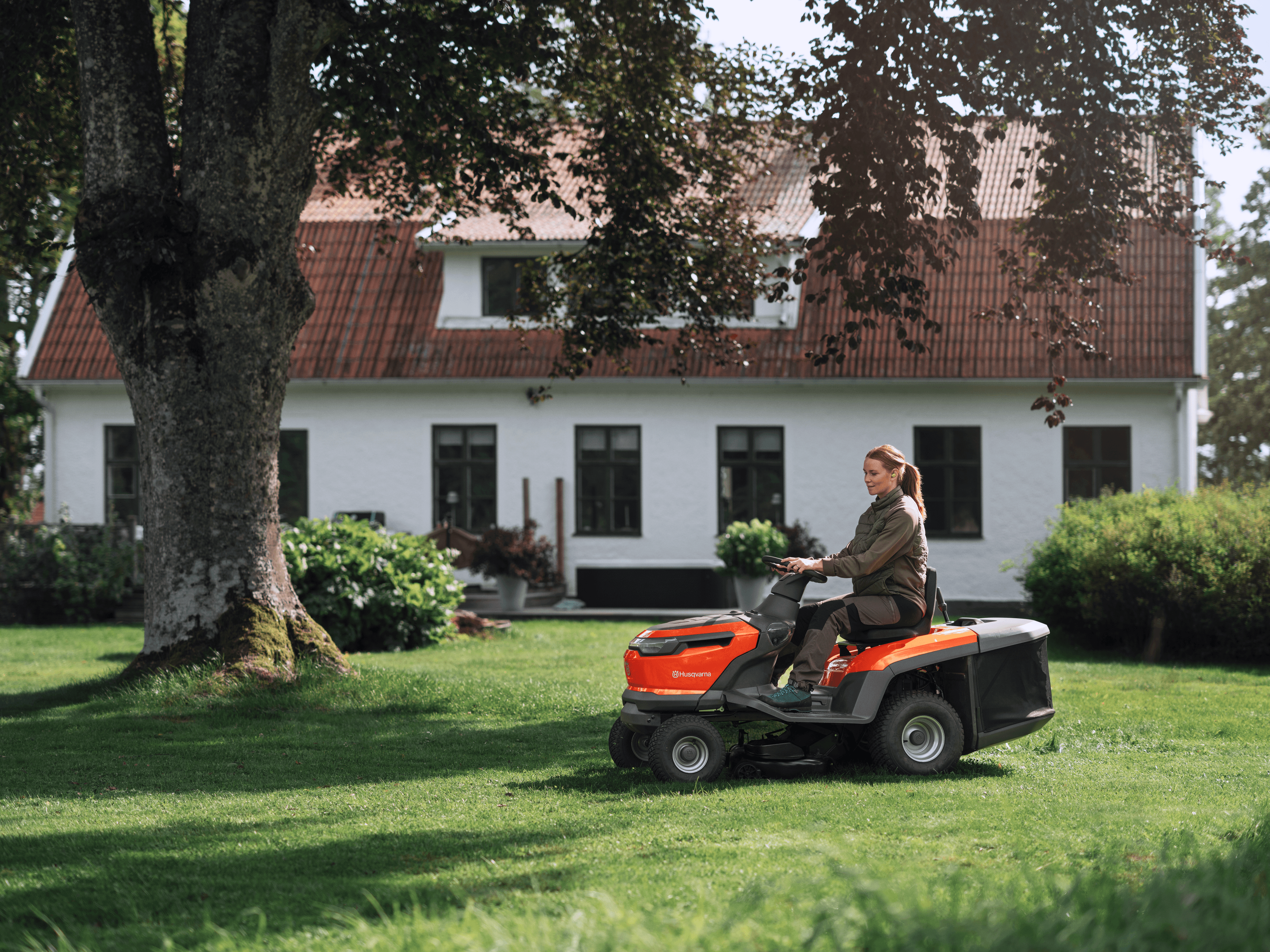 man holding polesaw whilst cutting tree